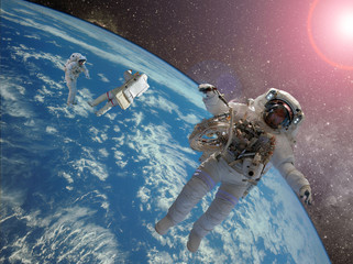 astrounaut spacewalk in the space on earth orbit at night. Elements of this image furnished by NASA f © Mihail