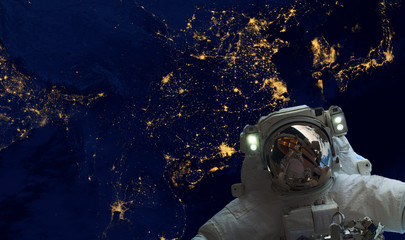 astrounaut spacewalk in the space on earth orbit at night. Elements of this image furnished by NASA...