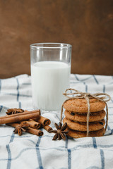 milk with homemade cookies decorated with cinnamon sticks and star anise
