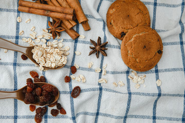 oatmeal cookies, oat flakes, raisins and cinnamon sticks. The view from the top. Ingredients for making cookies