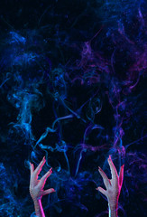 Conceptual photo of pentagram, made of smoke and hands of a necromancer trying to call the devil....