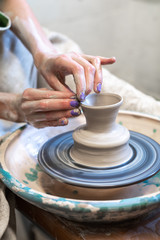 Vertical photo of handicraft workmanship lady in her workwear she sit inside workspace make craft product enjoy process and good idea