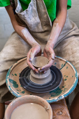 Master class concept. Vertical photo of workmanship lady artist in her workwear she sit indoor workspace make best clay ceramics product by hands