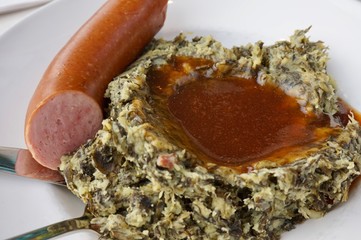 Dutch Boerenkool Stamppot (mashed pot of mashed potatoes mixed with kale), smoked sausage and a...
