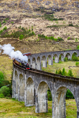 Glenfinnan Viaduct, Scotland. Travel/tourist destination in Europe. Old historical steam train...