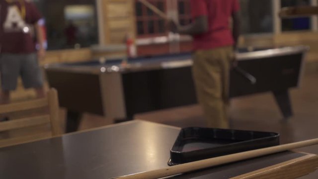 Slider Shot Of Ping Pong Paddle With Teens Playing In Background 2