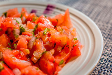 dish of cold Moroccan salad made of tomato onions and parsley