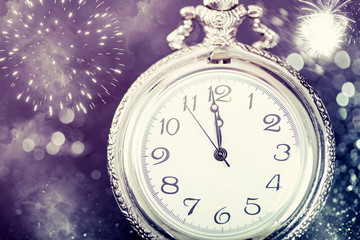 Fototapeta na wymiar New Year's at midnight - Old clock and holiday lights
