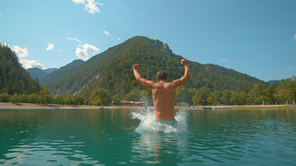 Fototapeta na wymiar CLOSE UP: Playful man having fun during summer vacation in Slovenian mountains.
