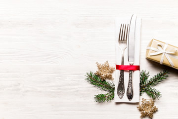Christmas table setting conceptual design with fork, knife and festive attributes. New Year banquet...