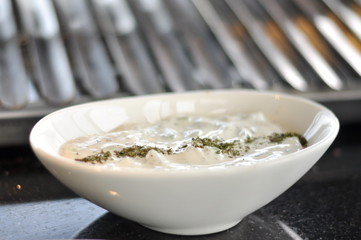 Traditional Cypriot meze and mix meat and chicken kebab table with charcoal barbecue on the table for self cooking during the eating time