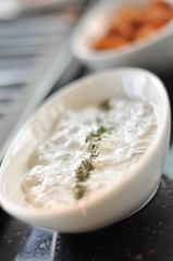 Traditional Cypriot meze and mix meat and chicken kebab table with charcoal barbecue on the table for self cooking during the eating time