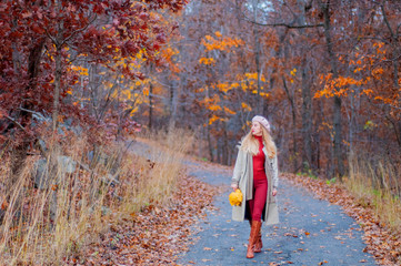 Fototapeta premium Beautiful woman is walking in the autumn forest.