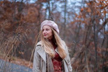 Beautiful elegant woman in the park in autumn