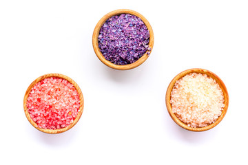 Spa salt background. Colorful spa salt in bowls on white background top view copy space