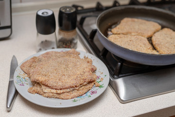 Preparing a pork chop in a home kitchen. Ingredients for a tasty dinner after work.