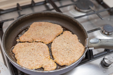 Preparing a pork chop in a home kitchen. Ingredients for a tasty dinner after work.