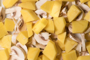 Background with cut potato and mushrooms ready for cooking