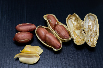 Peanuts on a black kitchen table. Tasty ingredients for peanut butter.