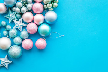 Toys for New Year tree 2019 background. Blue and pink balls and stars on blue background top view space for text border