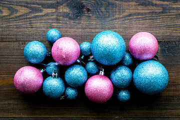 Toys for New Year tree 2019 background. Blue and pink balls on dark wooden background top view