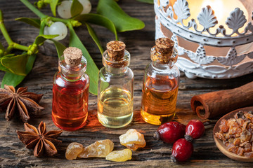 Christmas collection of essential oils with frankincense, myrrh, cinnamon, rose hips and mistletoe