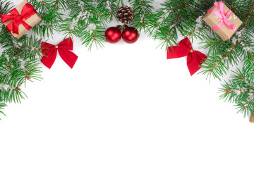 Christmas Frame of Fir tree branch with red bows isolated on white background with copy space for your text
