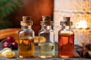 Christmas collection of essential oils with frankincense, star anise, rose hips and dried orange