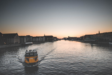 Yellow boat in the port of Copenhagen at sunset