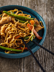 Asian noodles with pork in teriyaki sauce, with green beans, carrots and shiitake mushrooms.