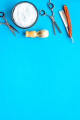 barbershop desk with tools for male care blue background top view mock-up