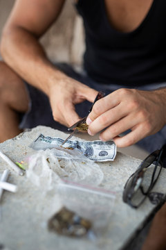 Man grinding cannabis buds