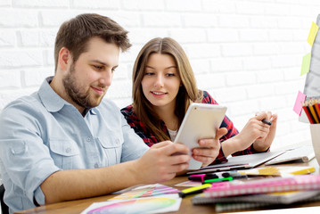 Team of creative designers working on a common project in a design studio