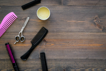 Set of professional hairdresser tools with combs wooden background top view mockup
