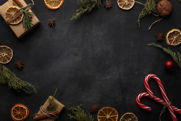 Christmas composition in rustic style on a black background. Top view. Copy space.
