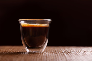 Cup of espresso coffee on wodden background.