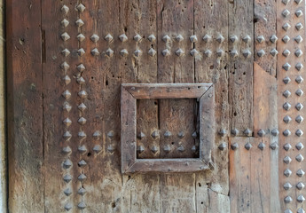 Part of the Valencia city ancient gates. Watch towers of Quart. Old wooden gate texture.   Strong fortress, Spain.
