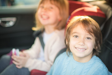 kids  sitting together in modern car