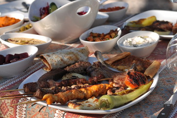 Traditional Cypriot meze and kebap barbecue party in the garden with delicious mix meat and chicken...