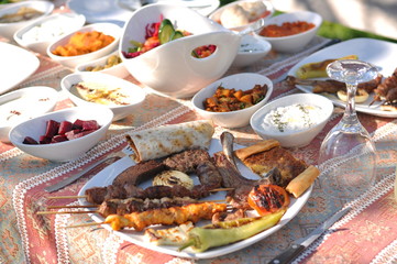 Traditional Cypriot meze and kebap barbecue party in the garden with delicious mix meat and chicken kebaps