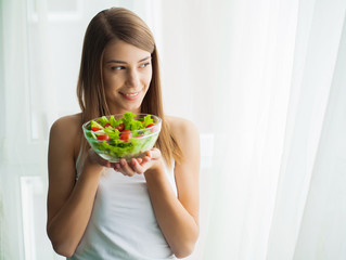 Diet and health.Young woman eating healthy food after workout