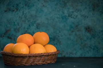 Fresh juicy clementines tangerines in a basket, fruit in winter. horizontal view of mandarin. copy...