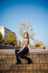 Photographing a girl during autumn with a blurred background