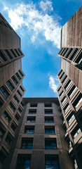 buildings from below angle to hte blue sky looking like key hole exit