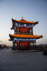 Fototapeta premium Beautiful illuminated traditional chinese temple on the Xi'An City Walls at evening, China
