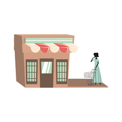 woman silhouette with shopping cart in store facade