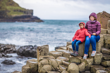 Mother and daughter at Giants causeway in autumn, Northern Ireland