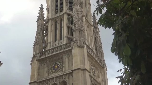 clock on a tower and leaves Paris, France