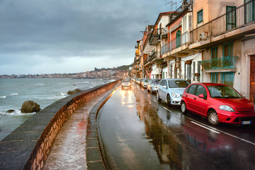 Waterfront with road in rainy weather at Giardini Naxos.  Taormina, Sicily, Italy