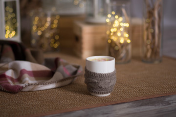 Cup of hot beverage in cozy Christmas interior